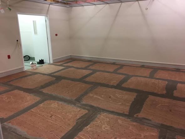 Vinyl flooring installed through a hallway and into adjoining rooms